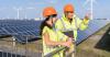 people in construction gear near solar panels