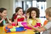 school kids laughing and eating lunch together