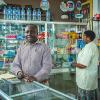 man and woman at counter in Tanzania pharmacy